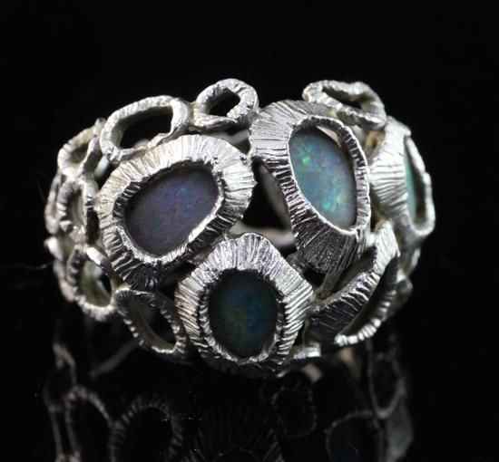A textured 18ct white gold and five stone white opal set free form ring, size M.